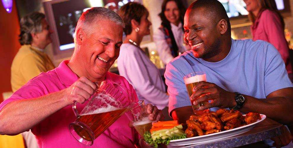Two Guys enjoying beer and wings | Dining at Hamburg Gaming